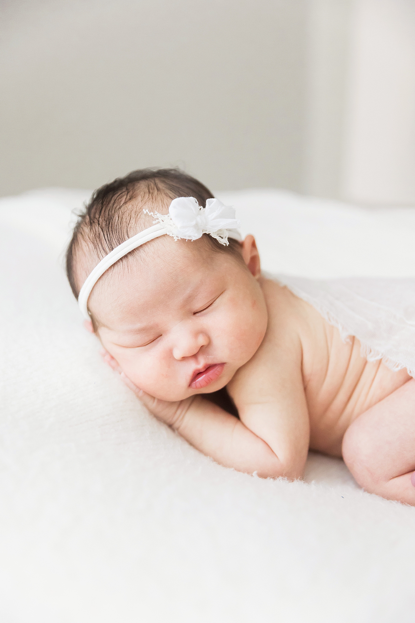 Baby girl posed on her belly. Photo by Fresh Light Photography.