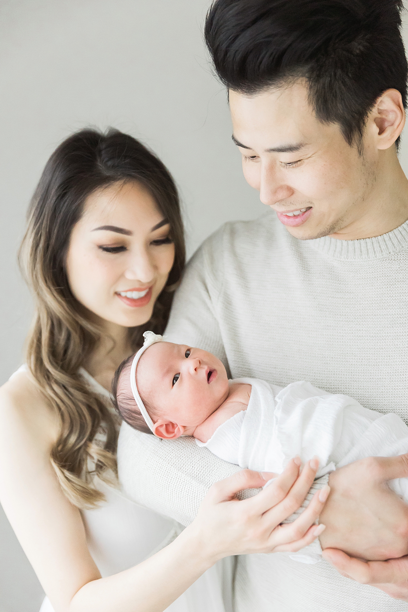 Studio newborn photo of parents and baby girl. Photo by Fresh Light Photography in Houston Heights.