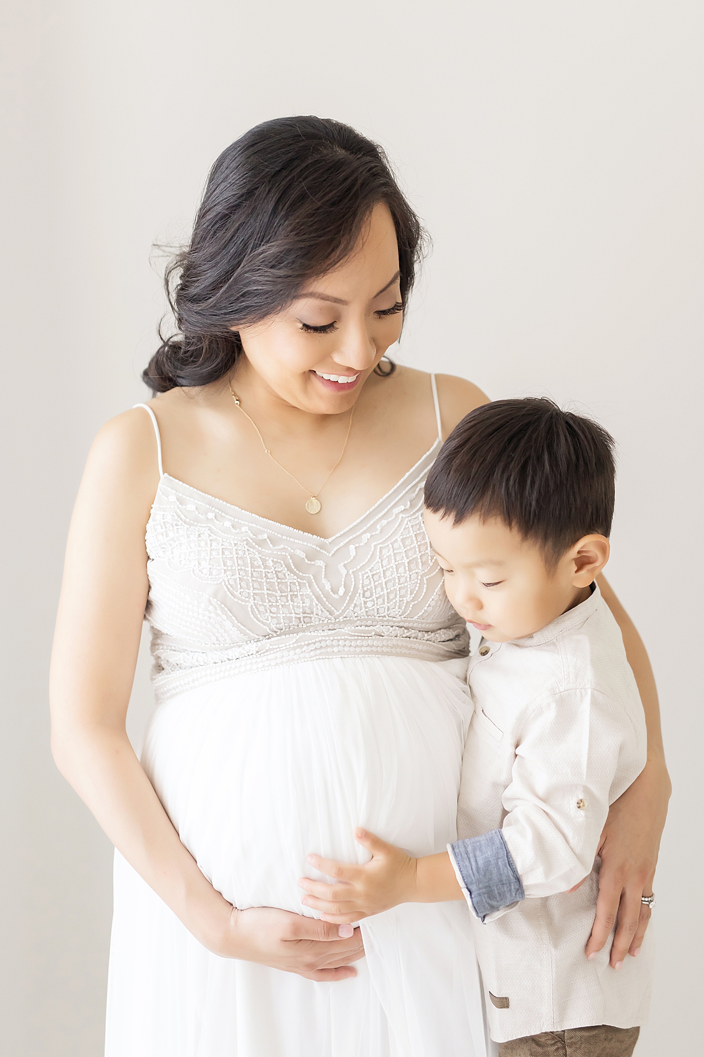 Mom and her first born son sharing a sweet moment during maternity photos with Fresh Light Photogrpahy.