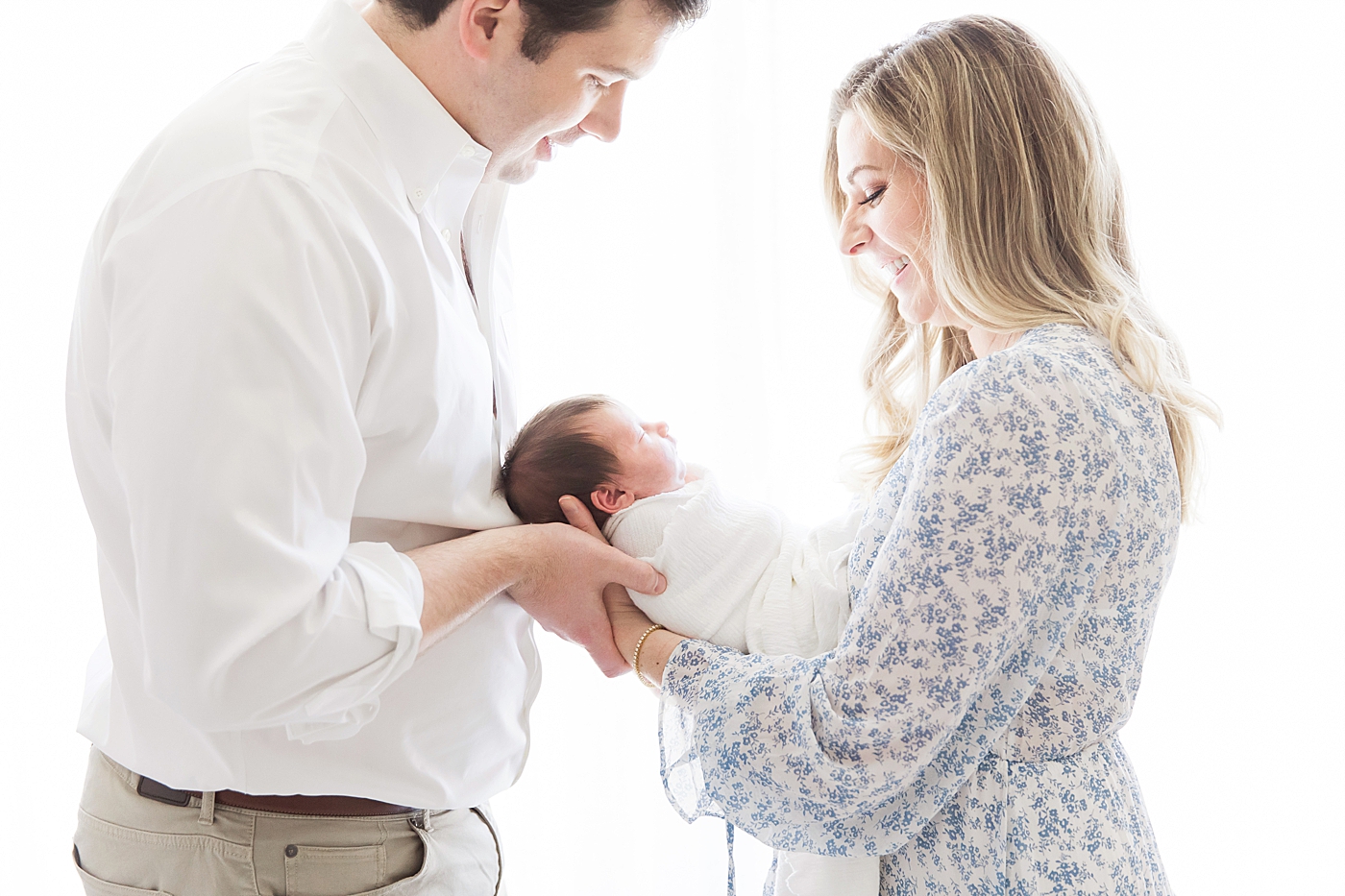 Backlit photo of parents and baby girl. Photo by Fresh Light Photography.
