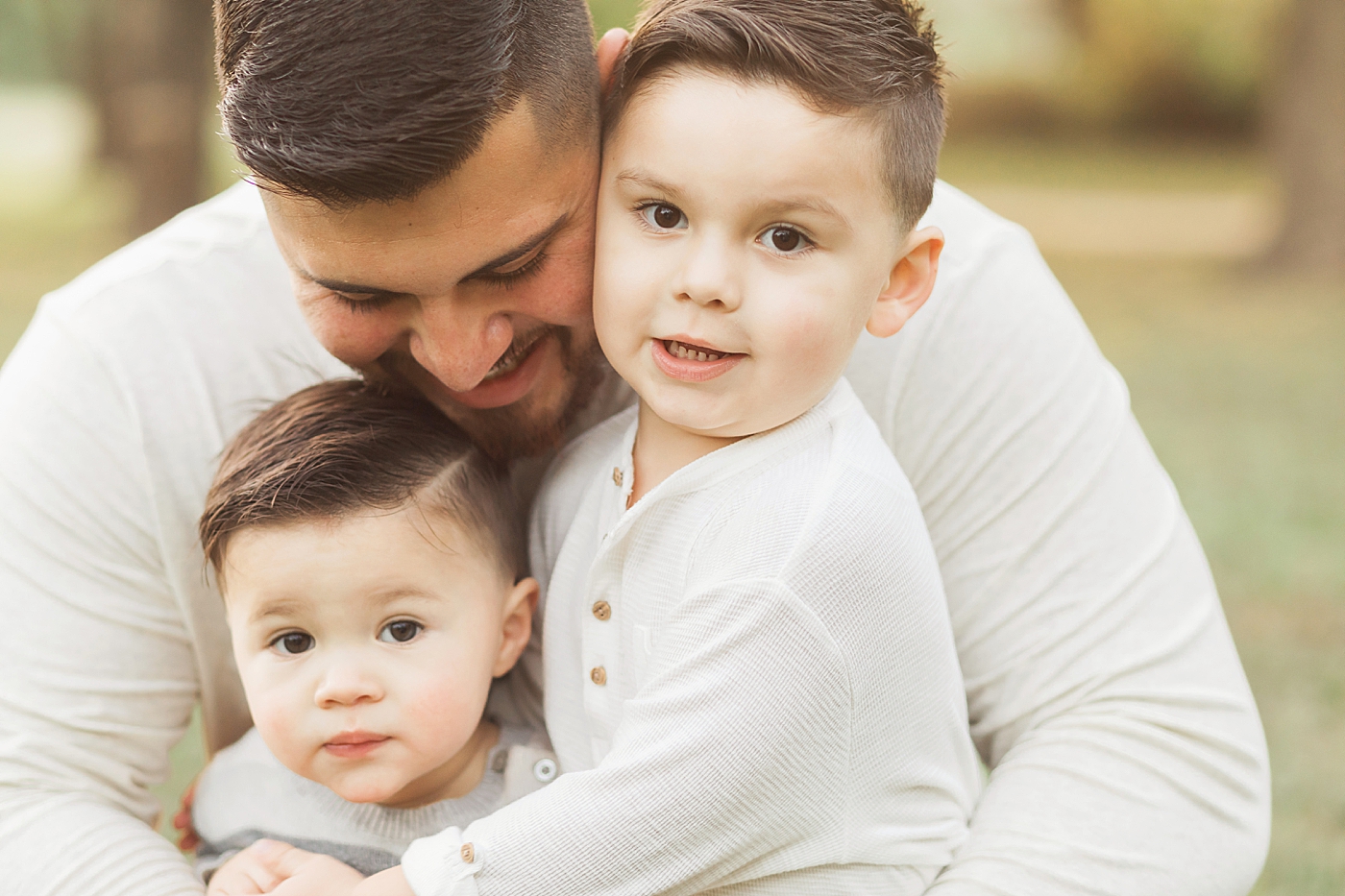 Dad hugging his boys. Photo by Fresh Light Photography.