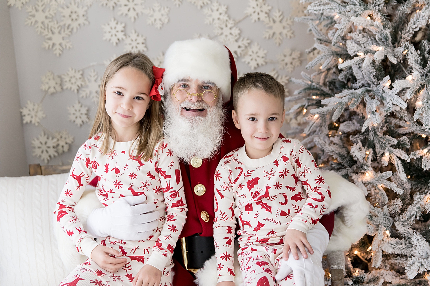 Brother and sister sitting on Santa's lap. Photo by Fresh Light Photography.