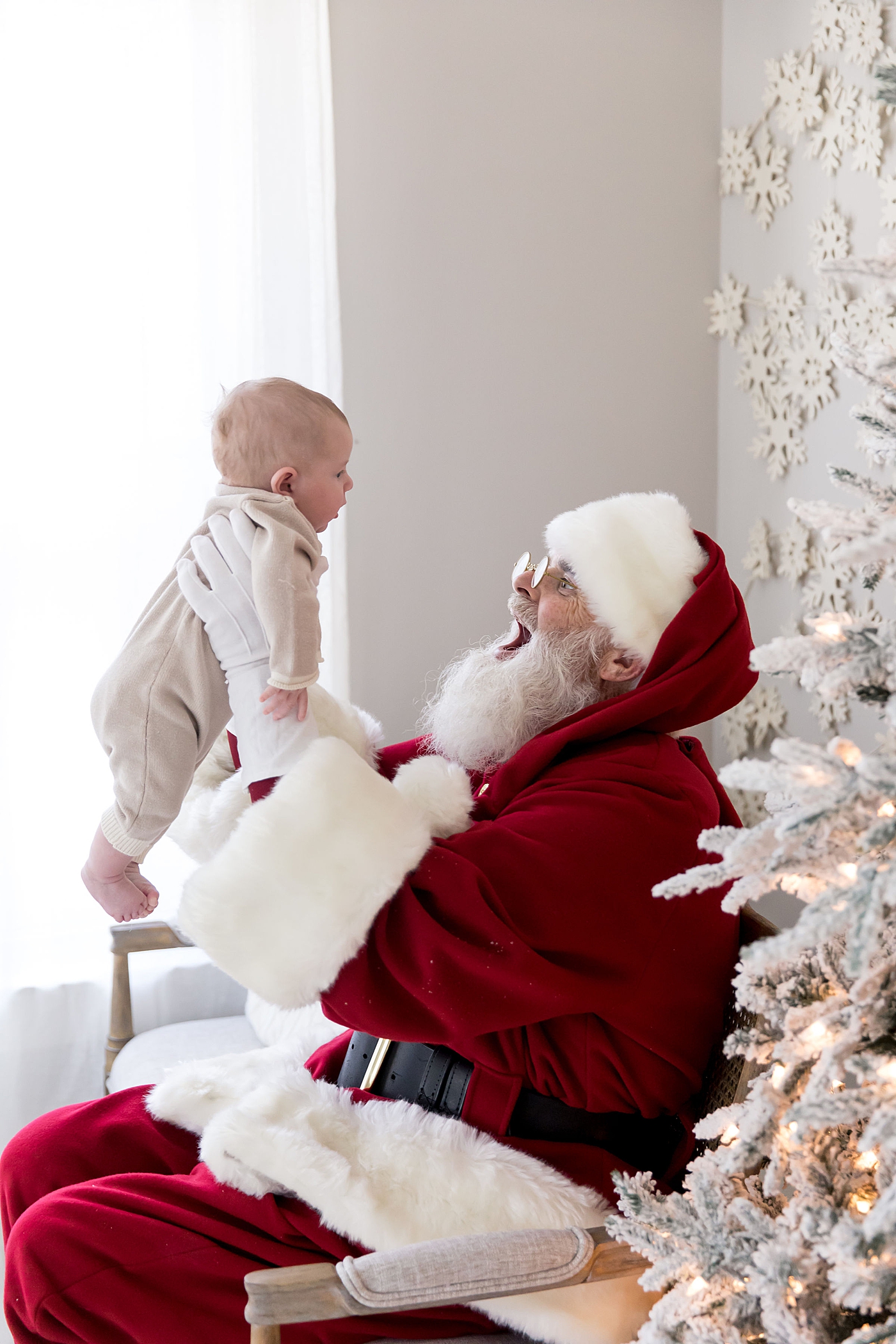 Santa holding baby during photoshoot in Houston. Photo by Fresh Light Photography.