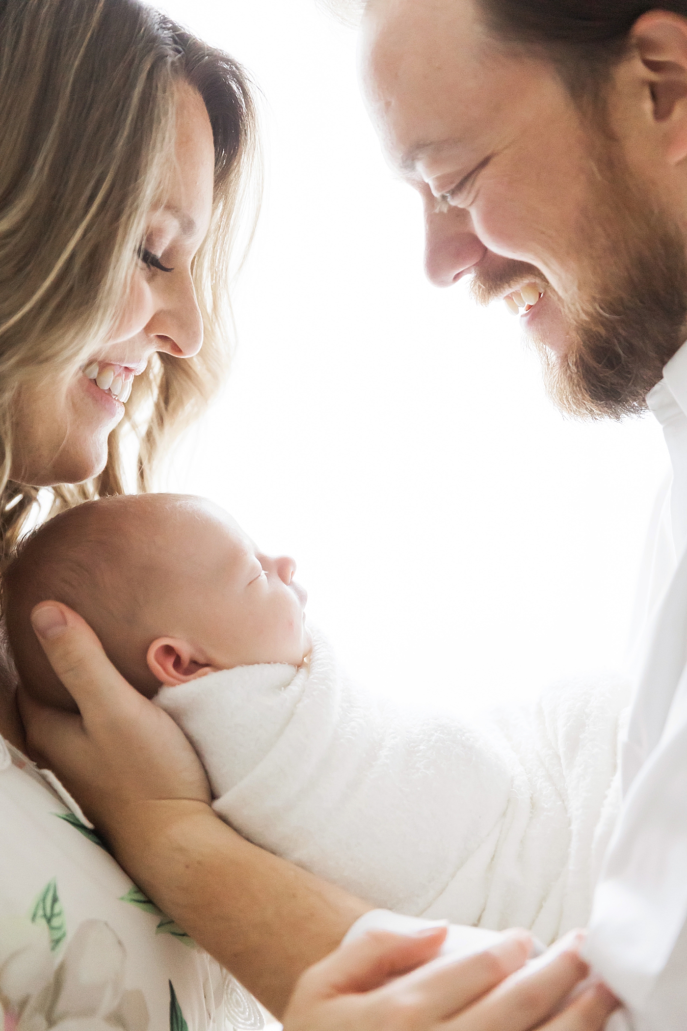 First time parents looking at baby boy. Photo by Fresh Light Photography.