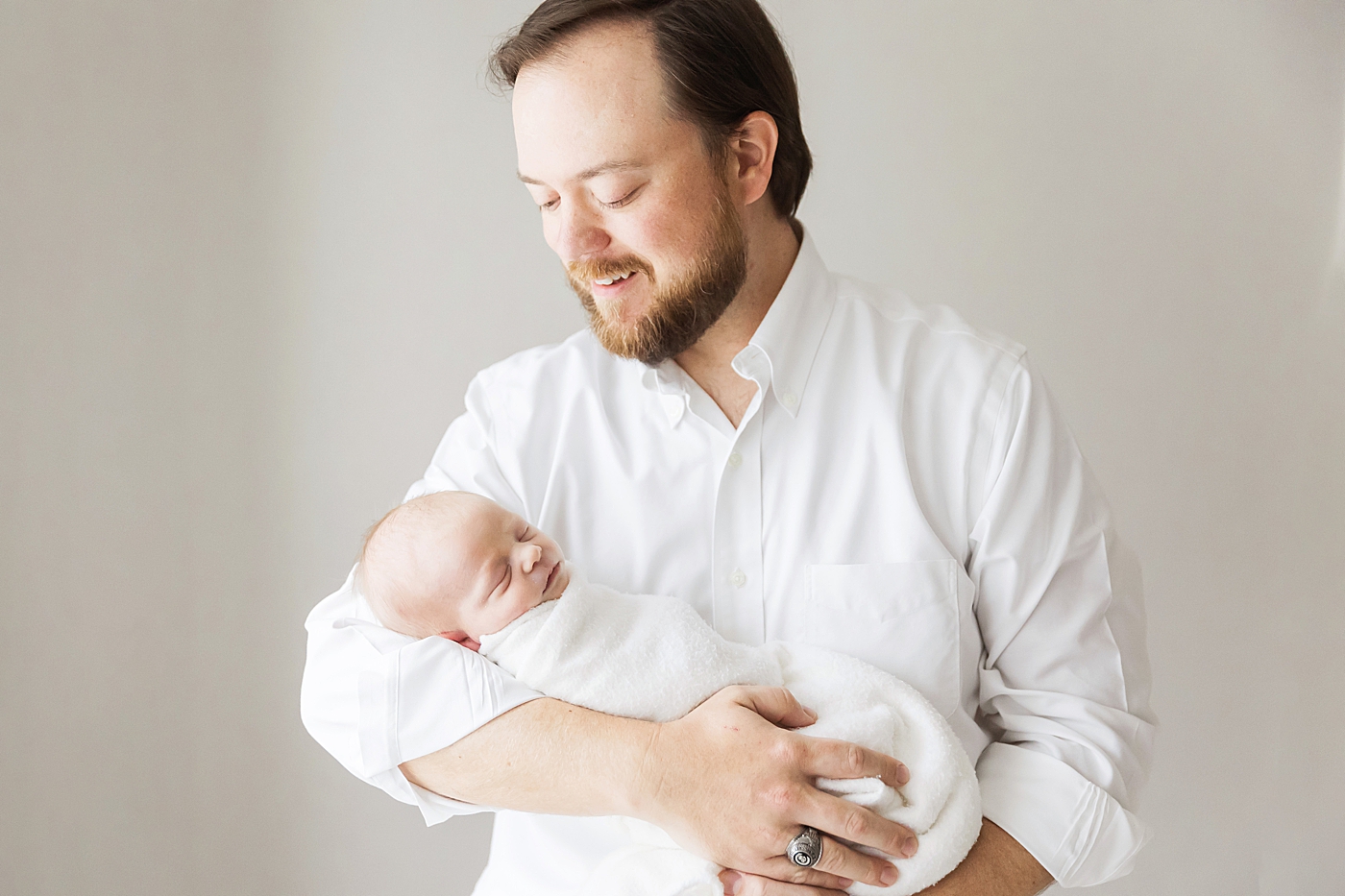 Dad holding son for newborn photos. Photo by Fresh Light Photography.