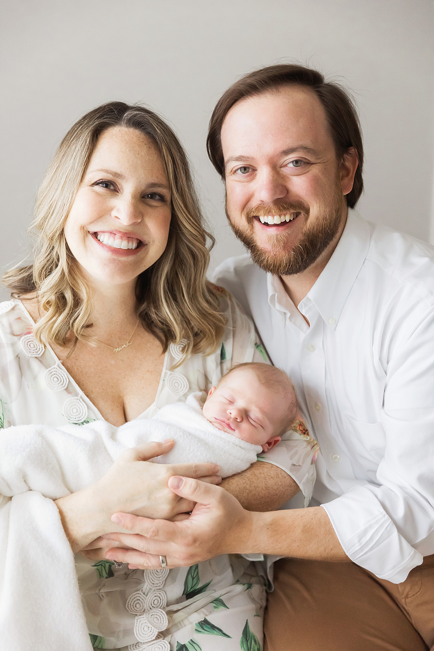 Family portrait of mom, dad and newborn son. Photo by Fresh Light Photography.