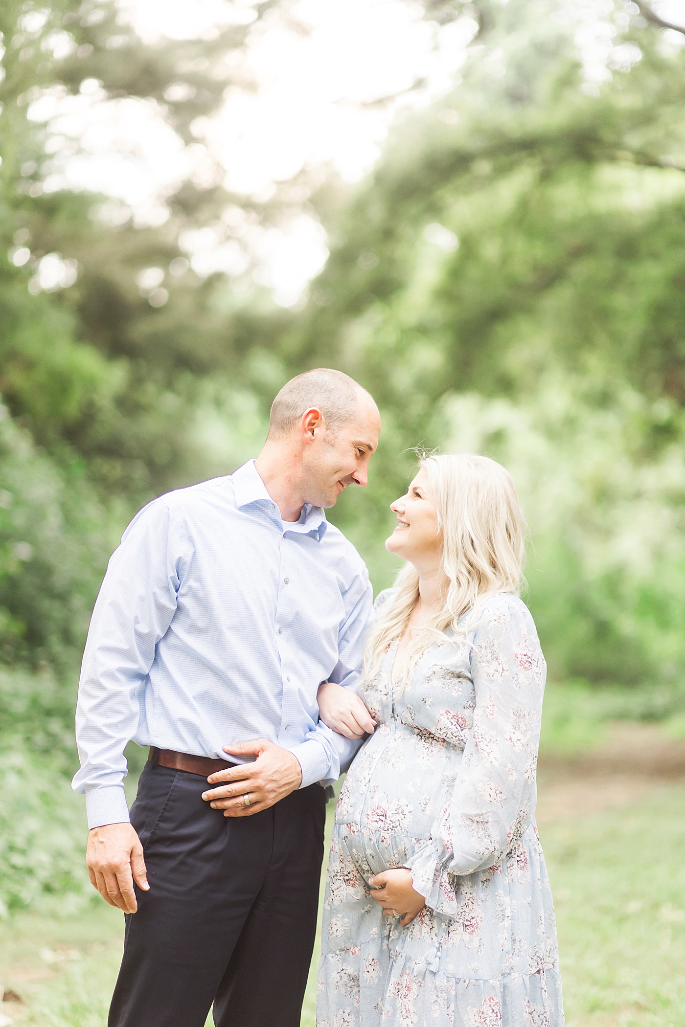Parents looking at each other during maternity session at White Oak Bayou. Photo by Fresh Light Photography.