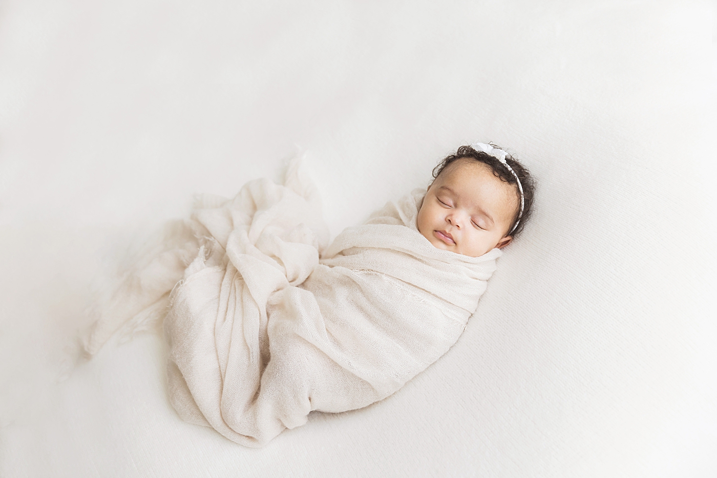 Baby girl swaddled in blanket for newborn photos at six weeks old. Photo by Fresh Light Photography.