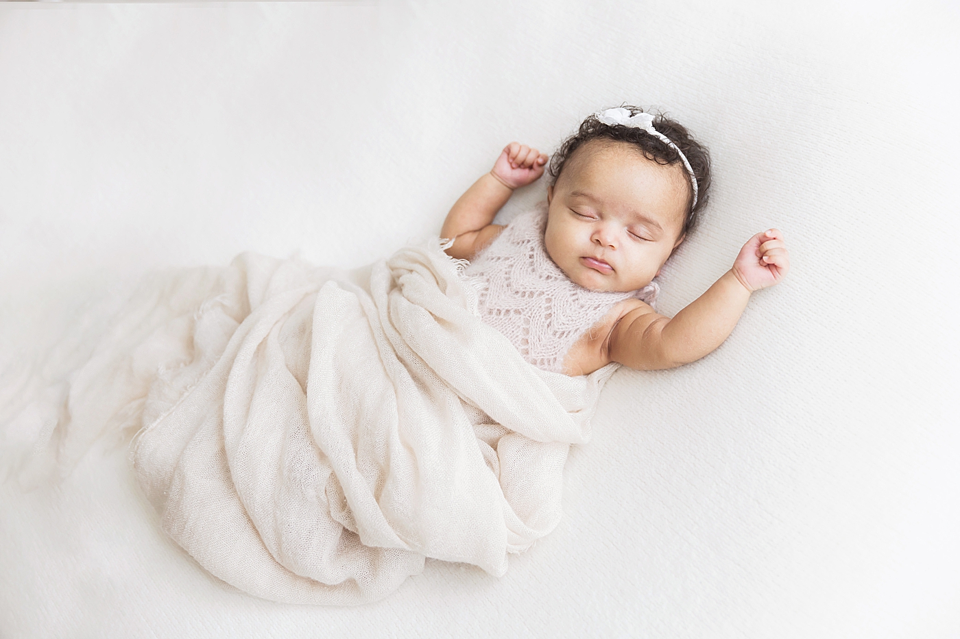 Baby girl laying with arms up. Photo by Fresh Light Photography.