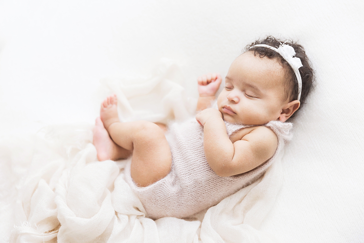 Baby girl curled up sleeping for newborn photos. Photo by Fresh Light Photography.