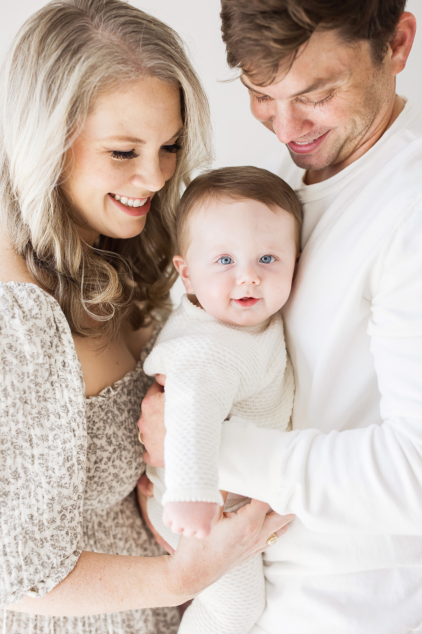 Mom and Dad with their six month old baby boy for milestone session in the studio with Fresh Light Photography.