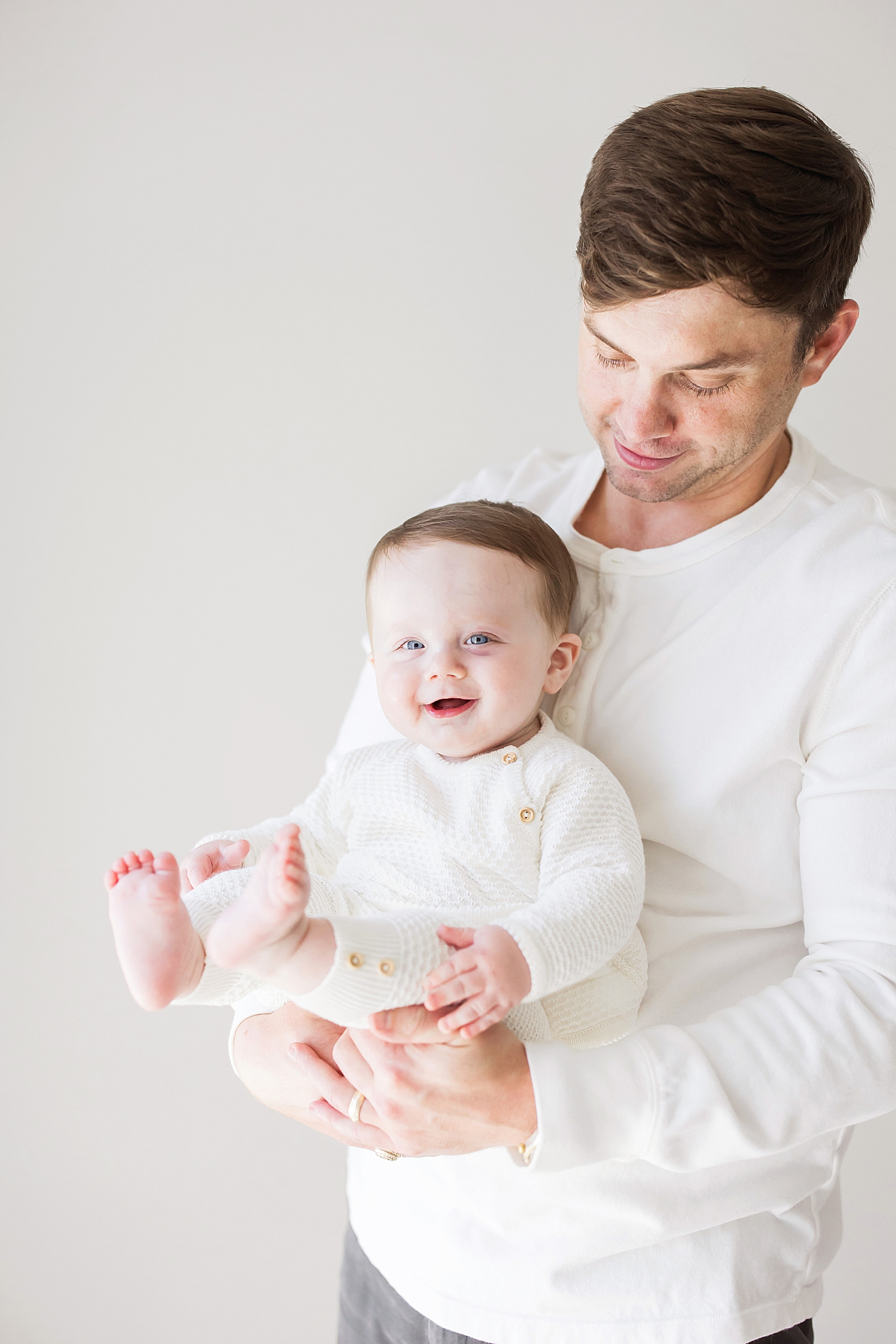 Dad holding six month old son. Photo by Fresh Light Photography