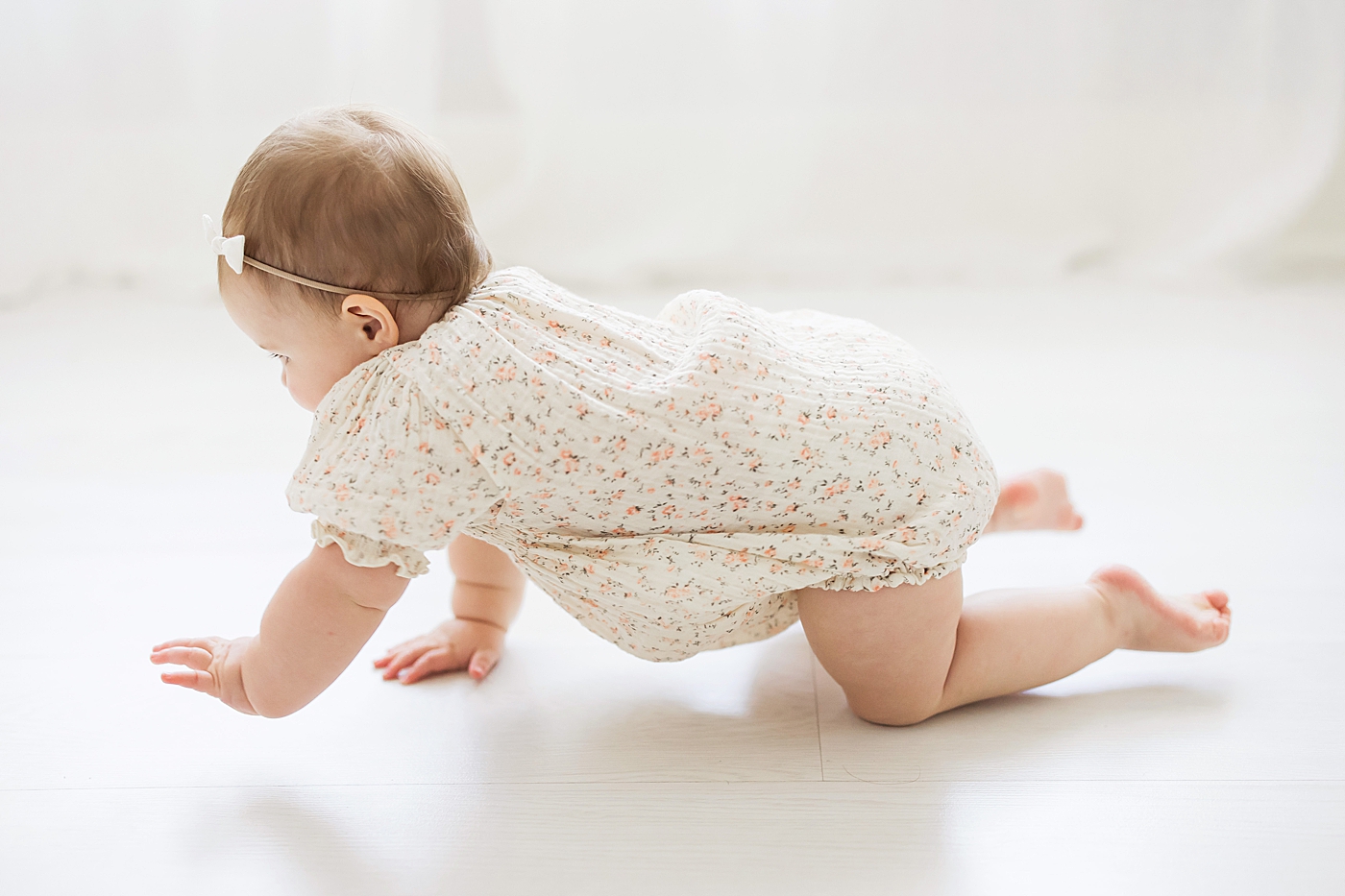 One year old baby girl crawling. Photo by Fresh Light Photography.