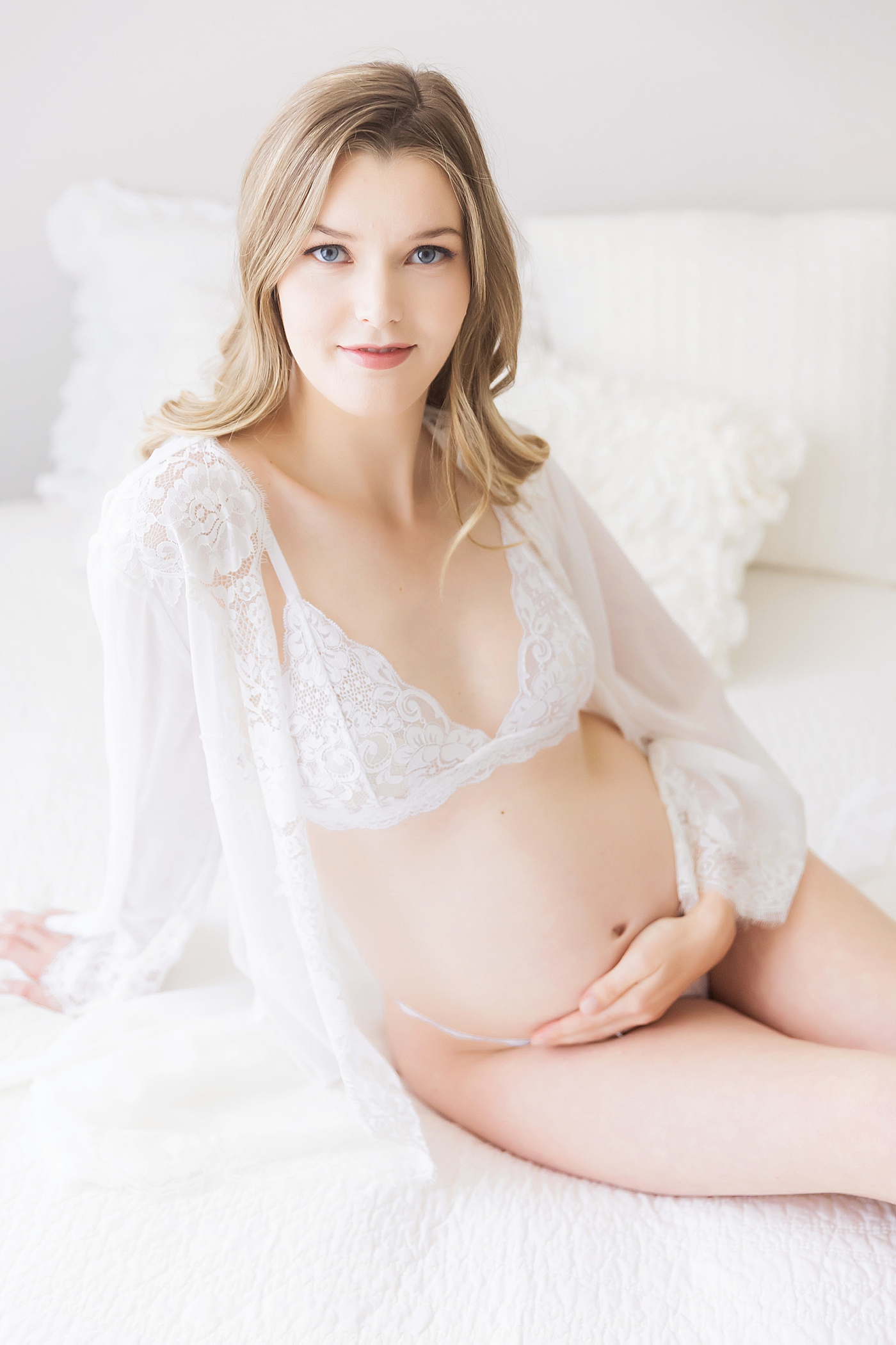 Expecting mom in white lace robe and undergarments for maternity photos. Photo by Fresh Light Photography.