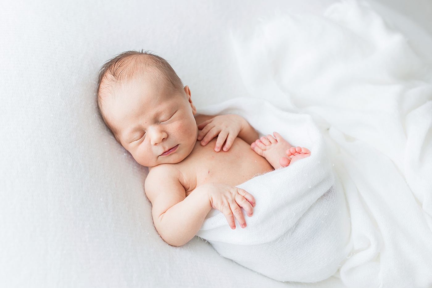 Baby boy swaddled in white blanket. Photos by Fresh Light Photography.