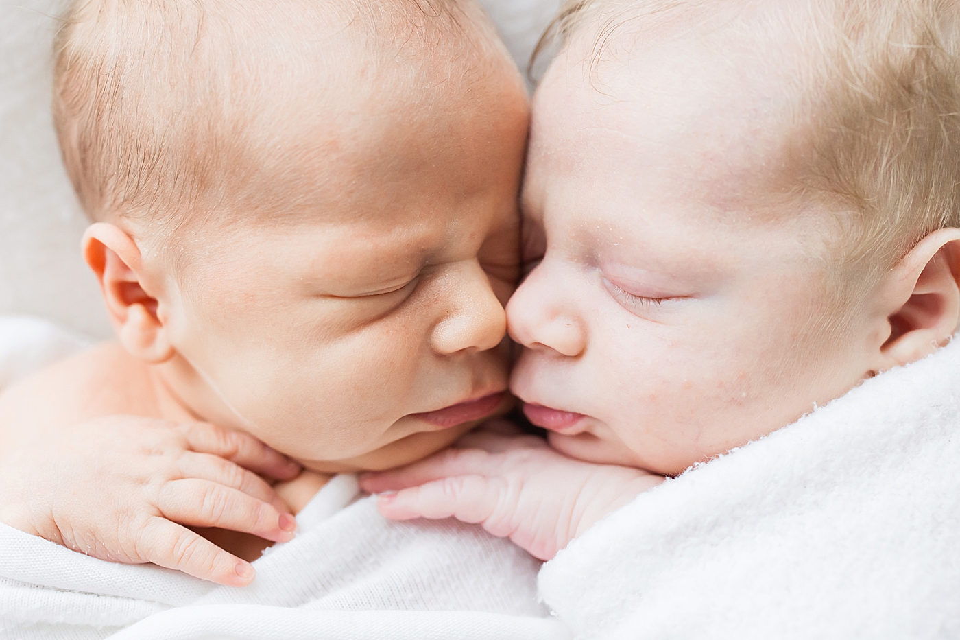 Twins snuggled up to each other during newborn session. Photos by Fresh Light Photography.