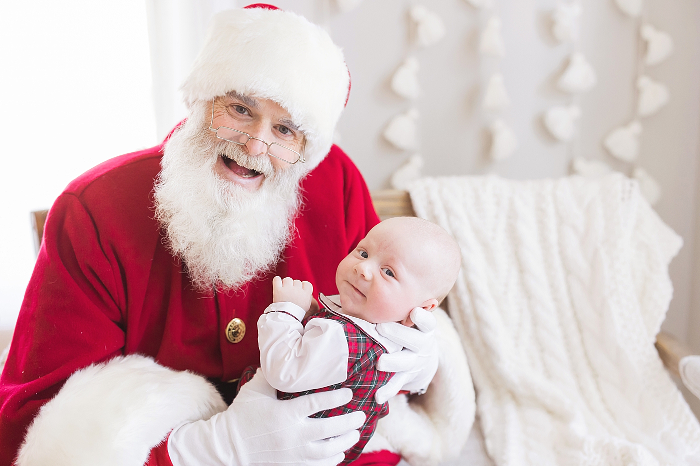 Santa holding baby for his first Christmas. Photo by Fresh Light Photography.