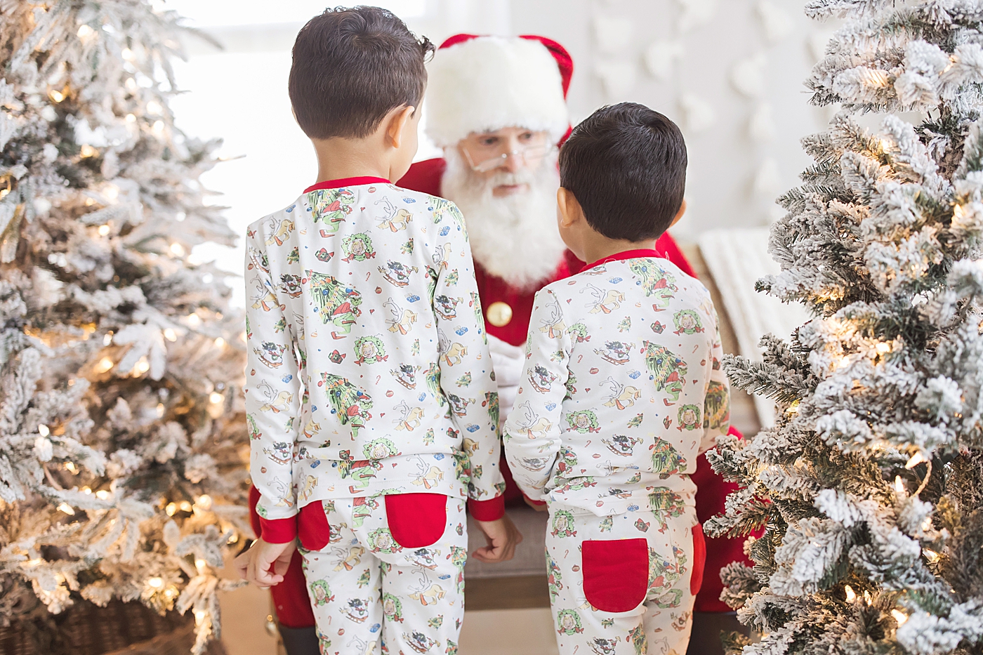 Kids visiting Santa in Christmas jammies. Photo by Fresh Light Photography.