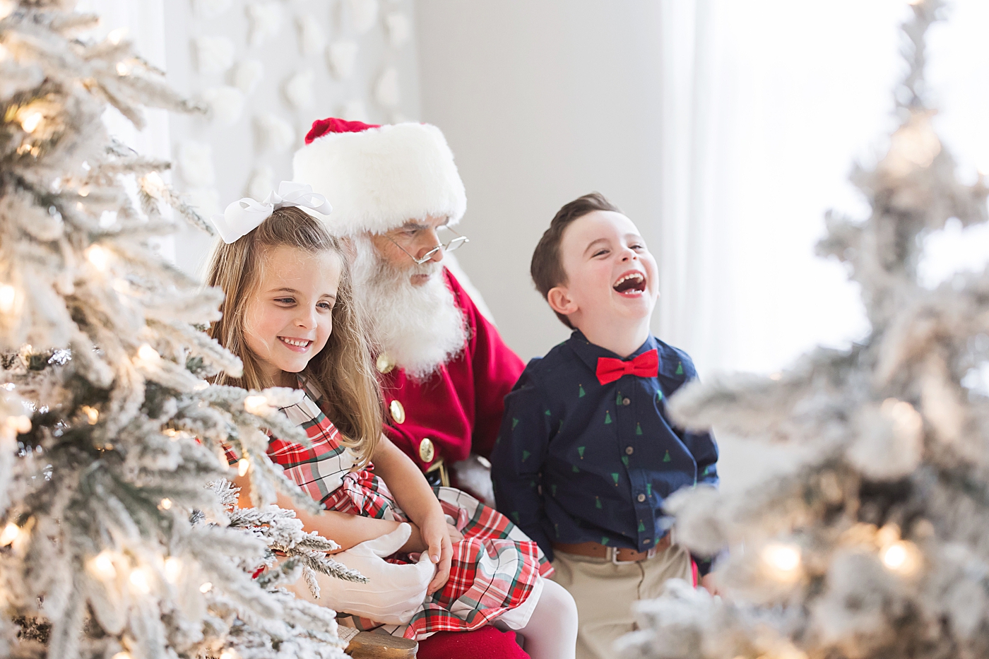 Kids laughing and visiting with Santa. Photo by Fresh Light Photography.