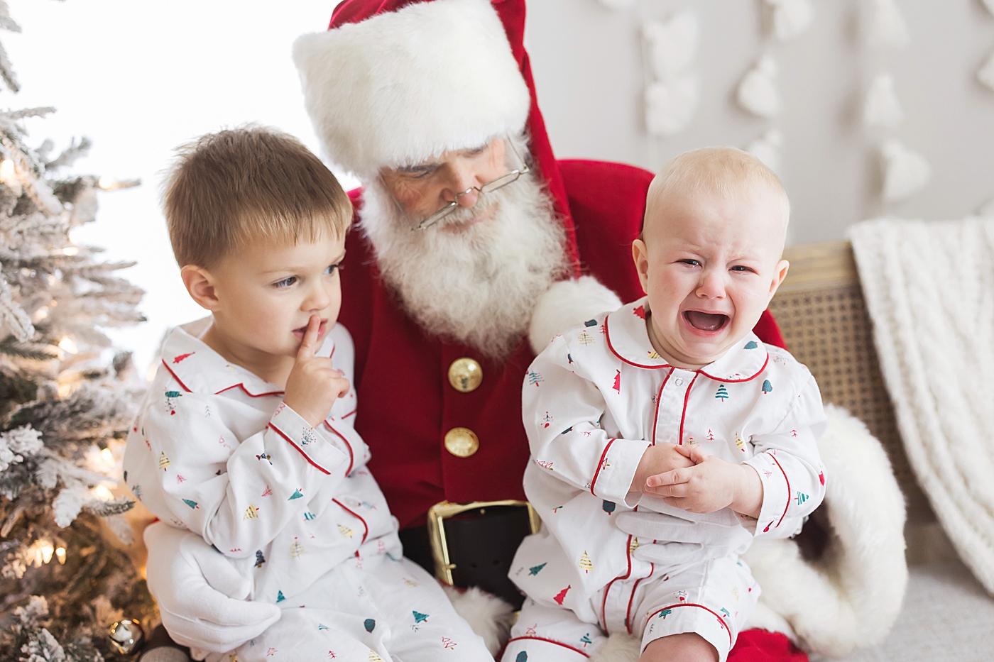 Brothers sitting on Santa's lap - youngest is crying. Photo by Fresh Light Photography.