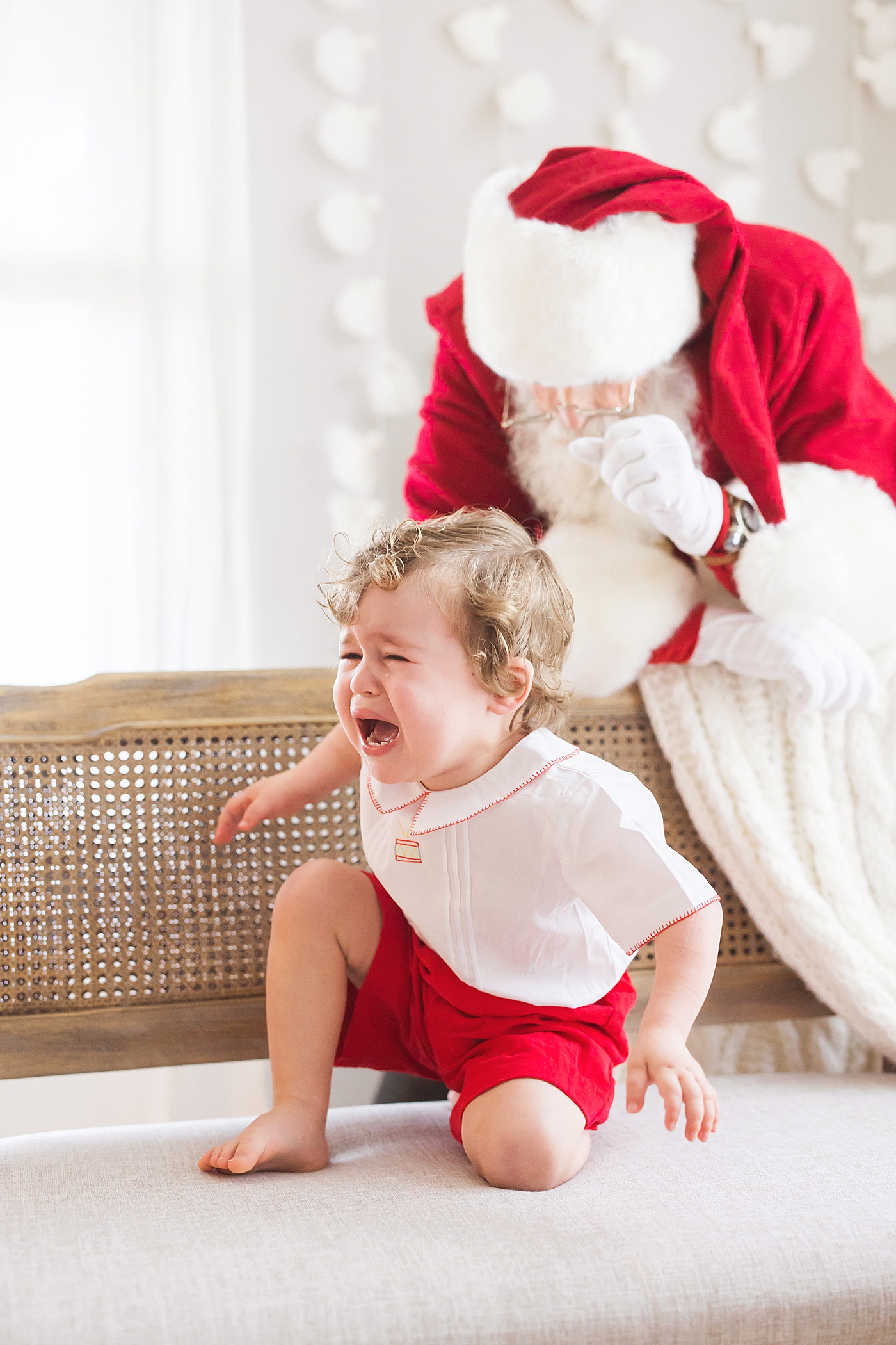 Toddler crying visiting Santa. Photo by Fresh Light Photography.