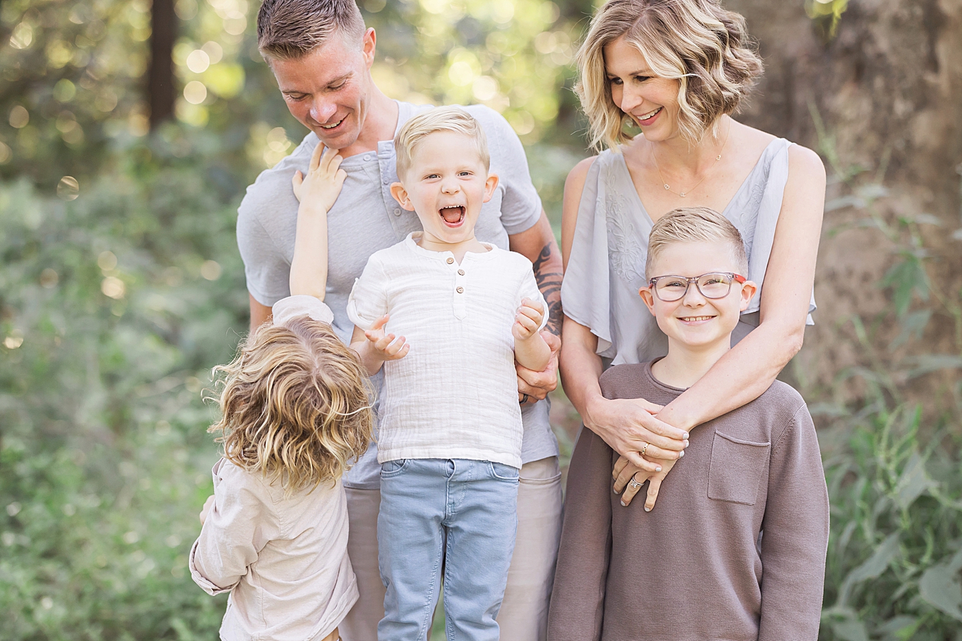 Boys laughing and smiling during family photos. Photo by Fresh Light Photography