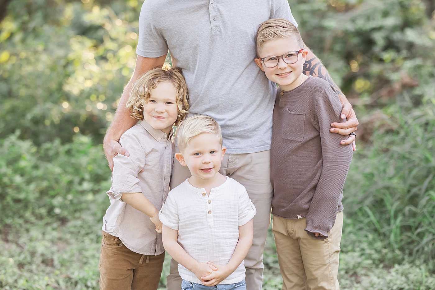 Dad with his three sons during outdoor family session in Houston Heights. Photo by Fresh Light Photography