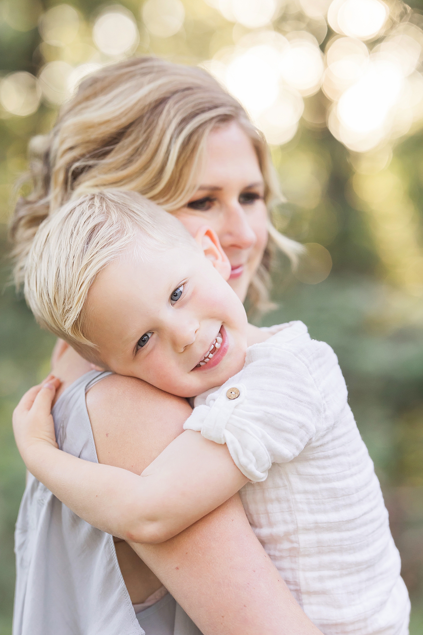 Mom holding her youngest son with his head on her shoulder. Photo by Fresh Light Photography