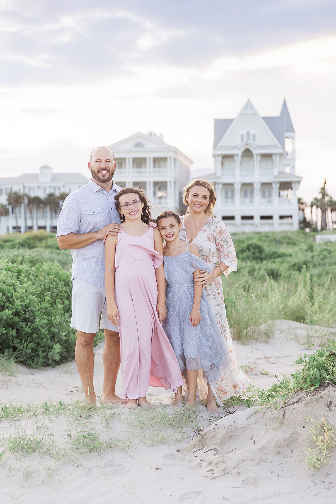 Family of four on the beach in Galveston. Photo by Fresh Light Photography.