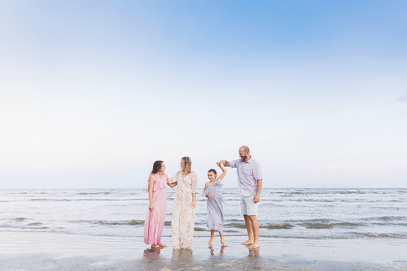 Family dancing on the beach. Photo by Fresh Light Photography.