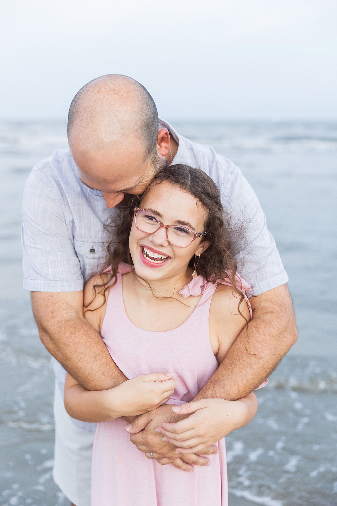 Dad hugging his oldest daughter. Photo by Fresh Light Photography.