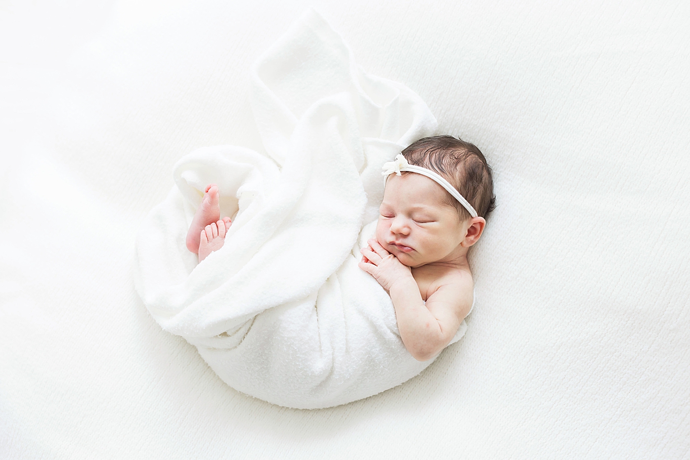 Baby girl swaddled in white for newborn photoshoot. Photo by Fresh Light Photography.