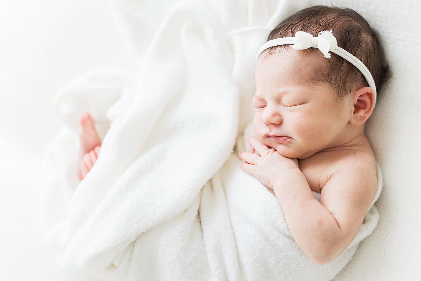 Baby girl curled up for newborn photos. Photo by Fresh Light Photography.