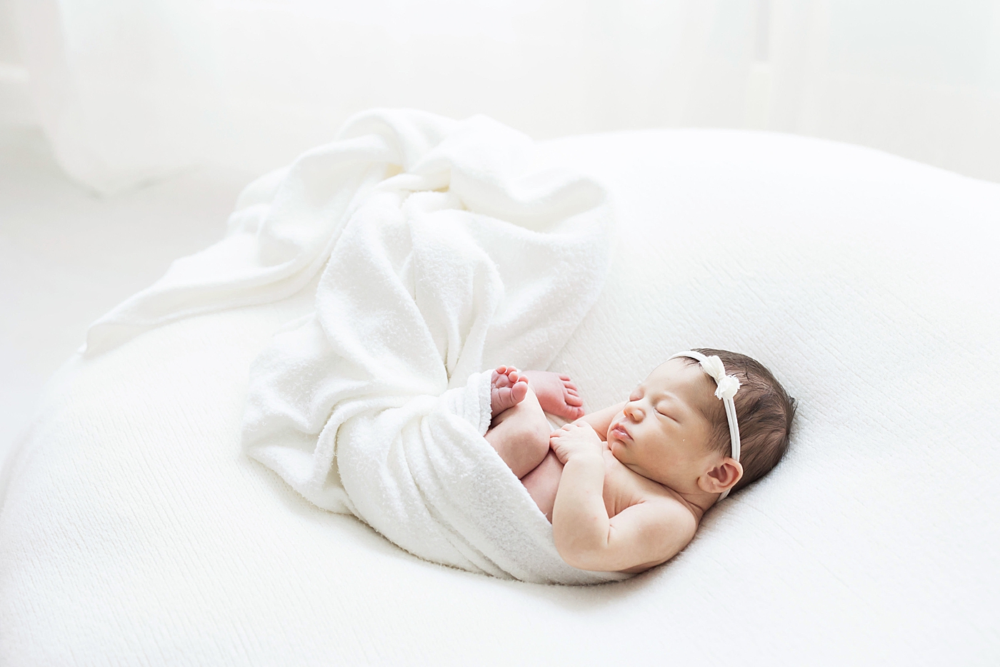 Newborn baby girl in all white. Photo by Fresh Light Photography.
