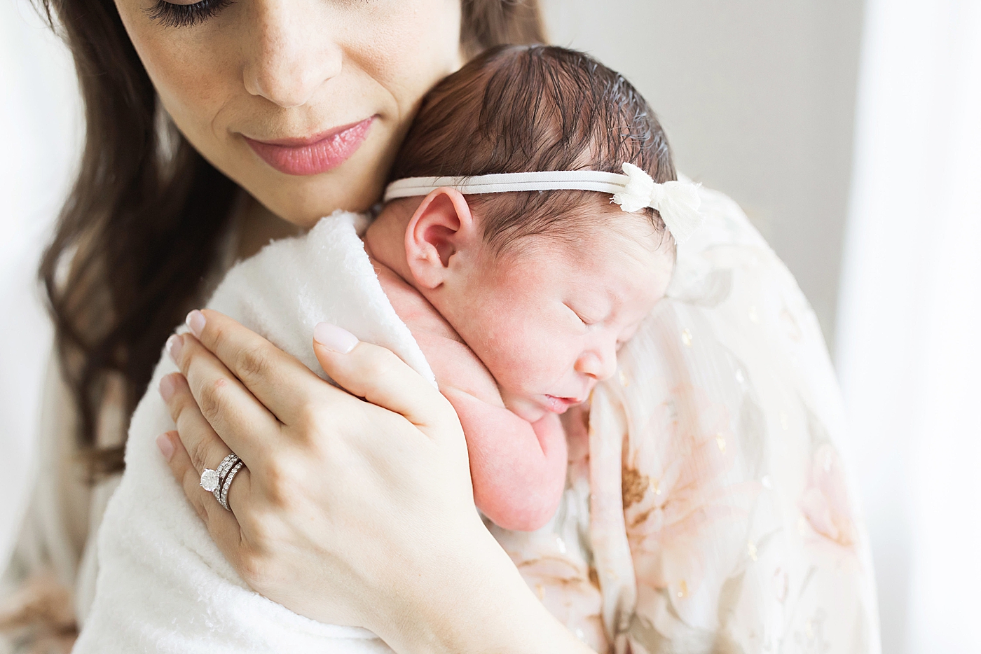Mom holding her newborn daughter. Photo by Fresh Light Photography.