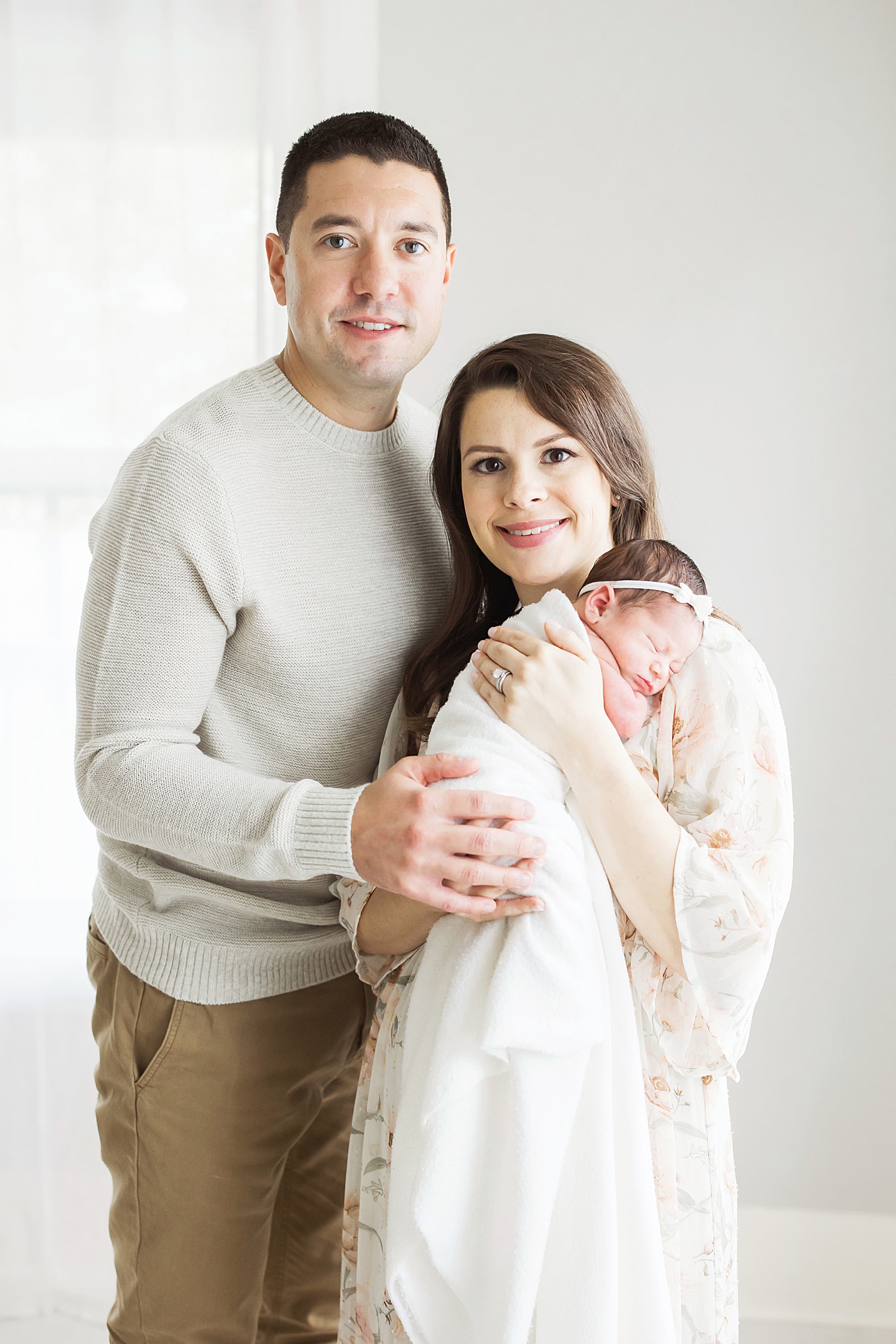 New parents with their newborn daughter. Photo by Fresh Light Photography.