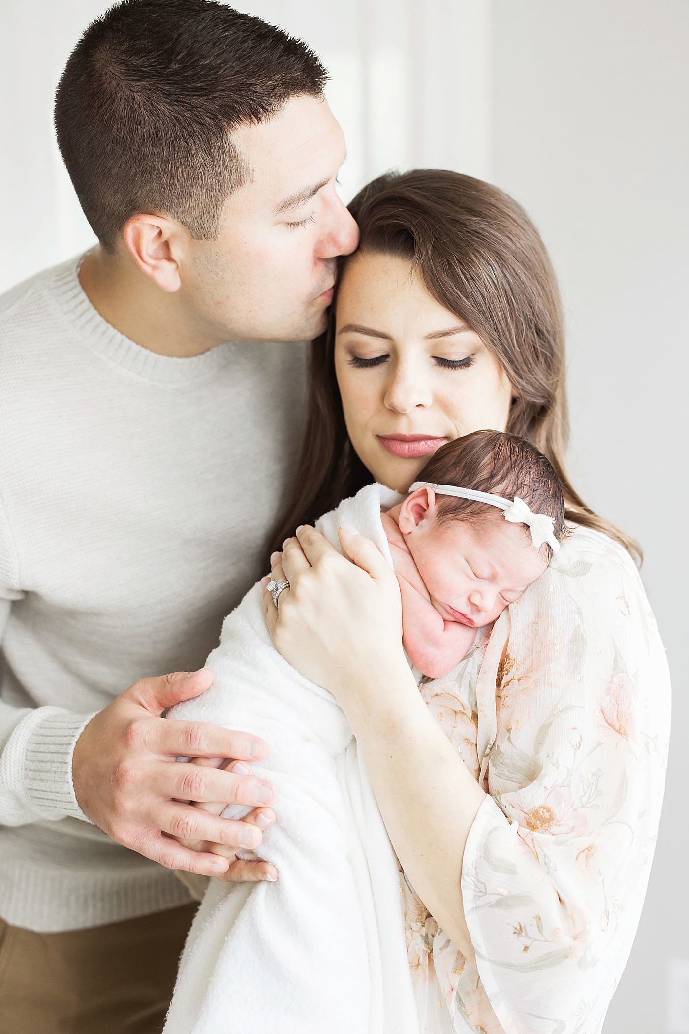 New parents with their newborn daughter. Photo by Fresh Light Photography.