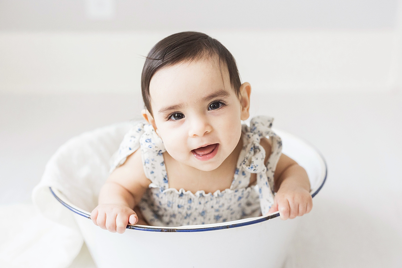 6 month old baby girl sitting in bowl for photos. Photo by Fresh Light Photography.