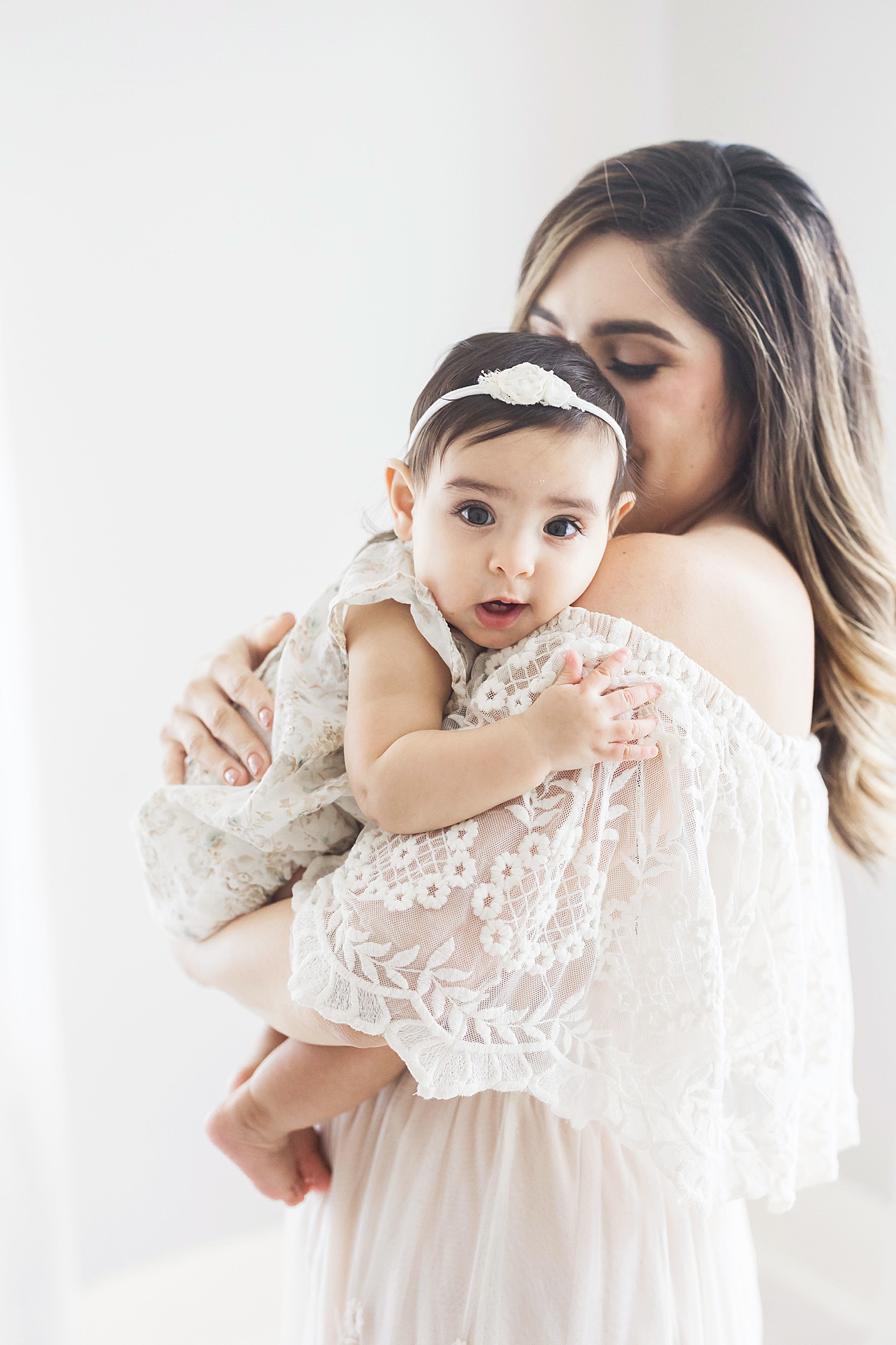 Six month old snuggled up on Mom's shoulder. Photo by Fresh Light Photography.