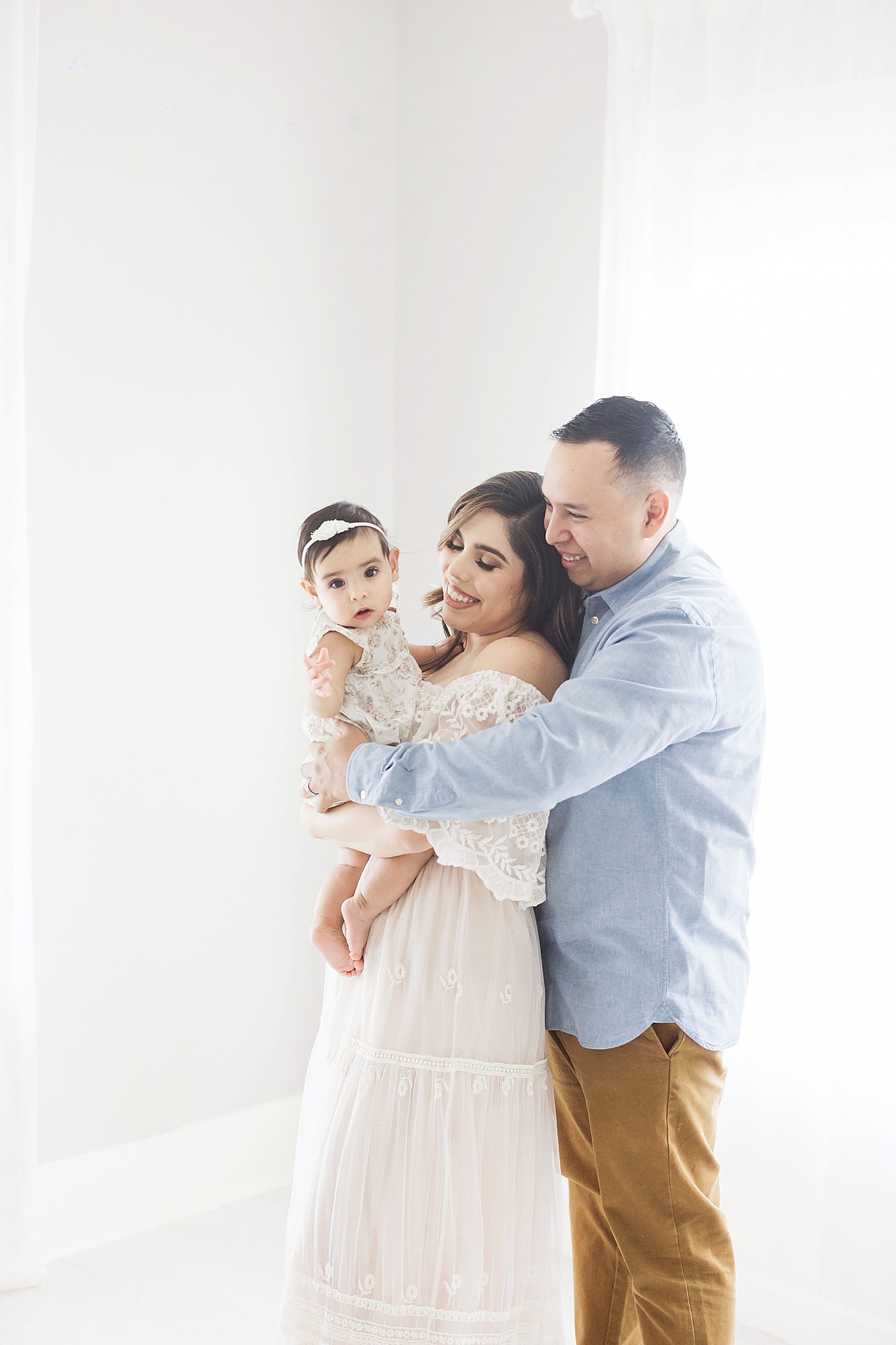 Mom, dad and six month old daughter. Photo by Fresh Light Photography.