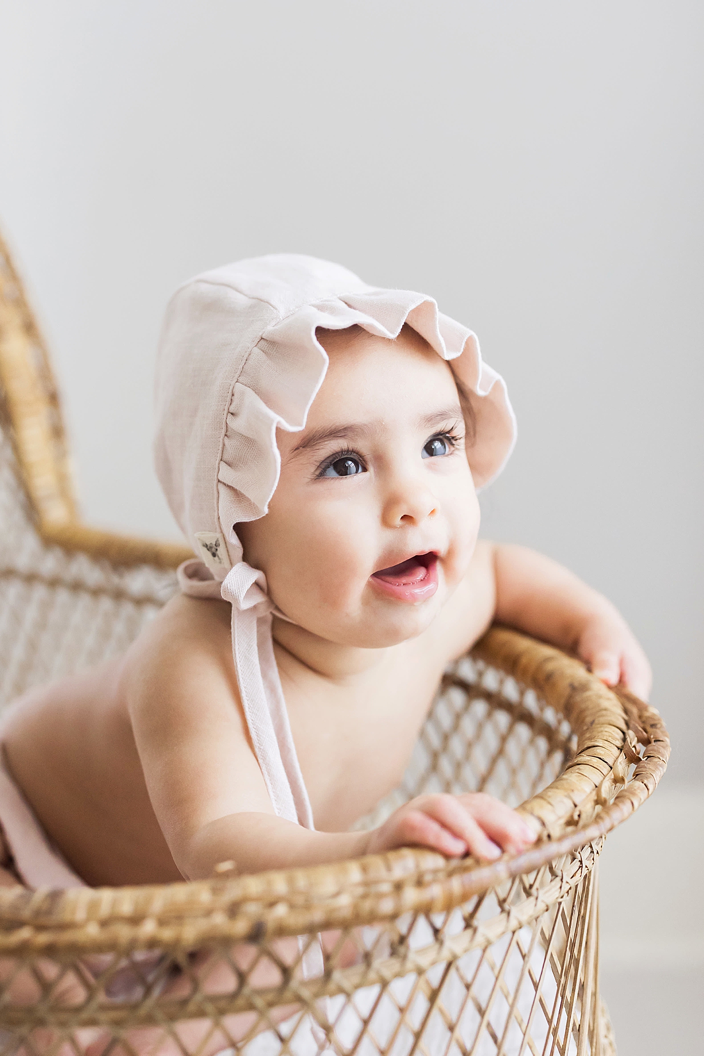 Six month old in light pink bonnet. Photo by Fresh Light Photography.