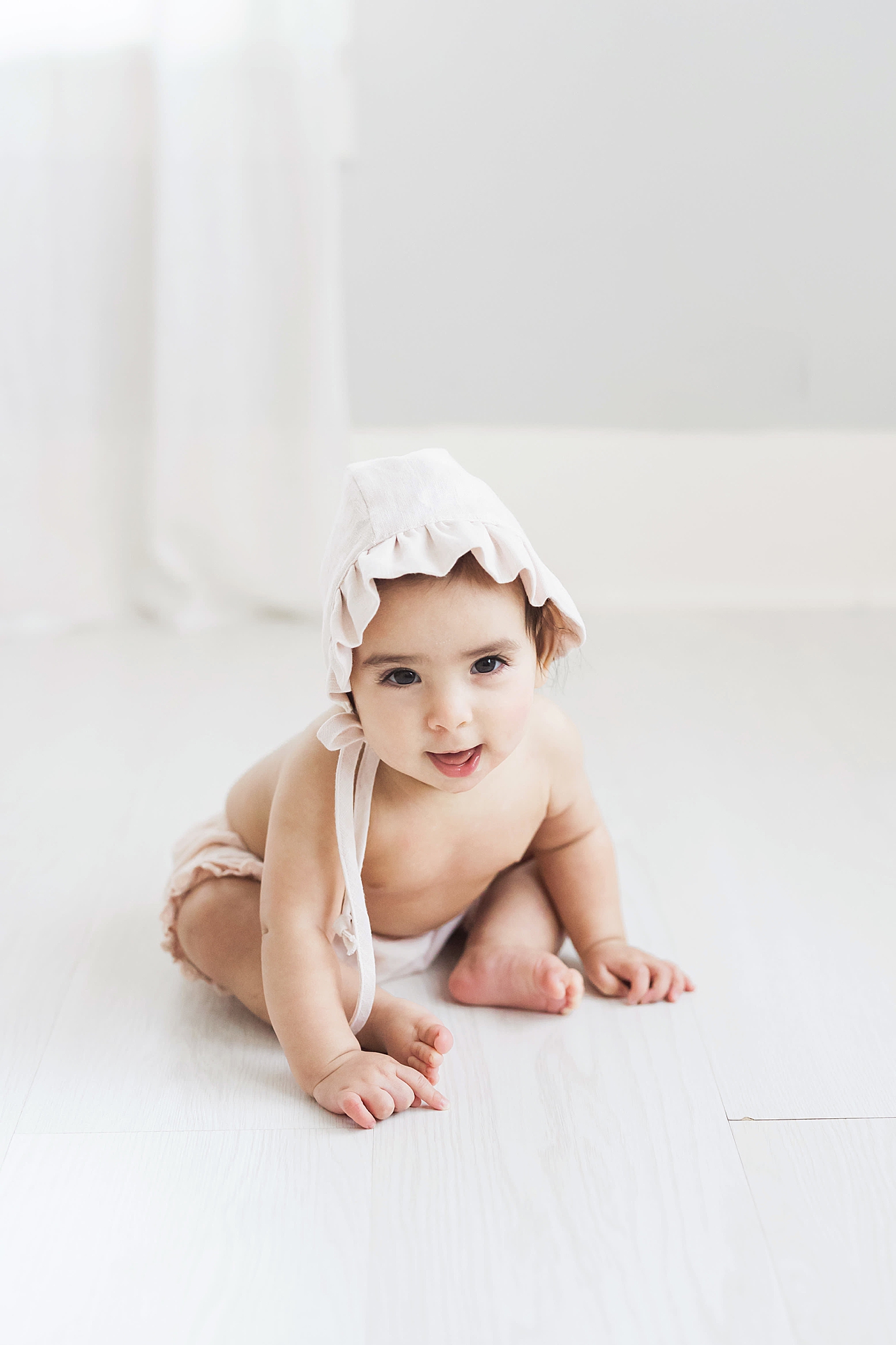 Six month old in light pink bonnet. Photo by Fresh Light Photography.