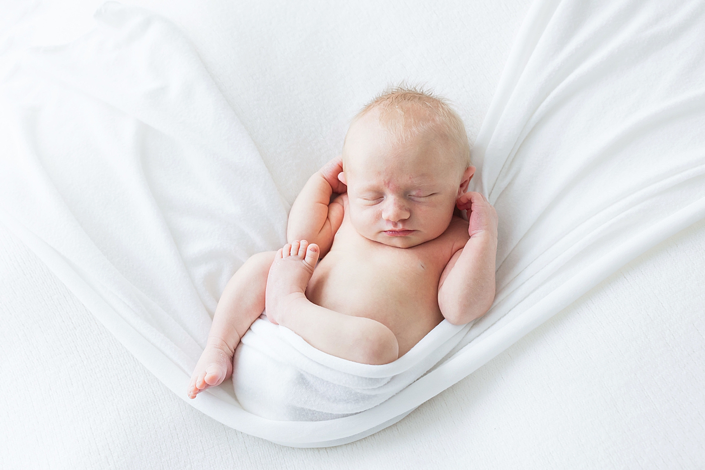 Relaxed newborn pose during session with Fresh Light Photography.