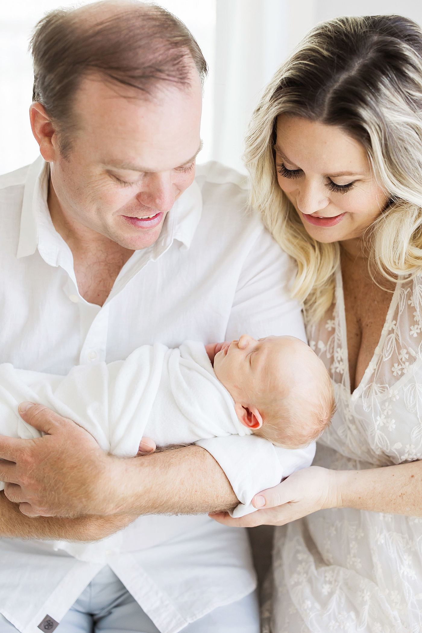 New parents with their newborn son. Photo by Fresh Light Photography.