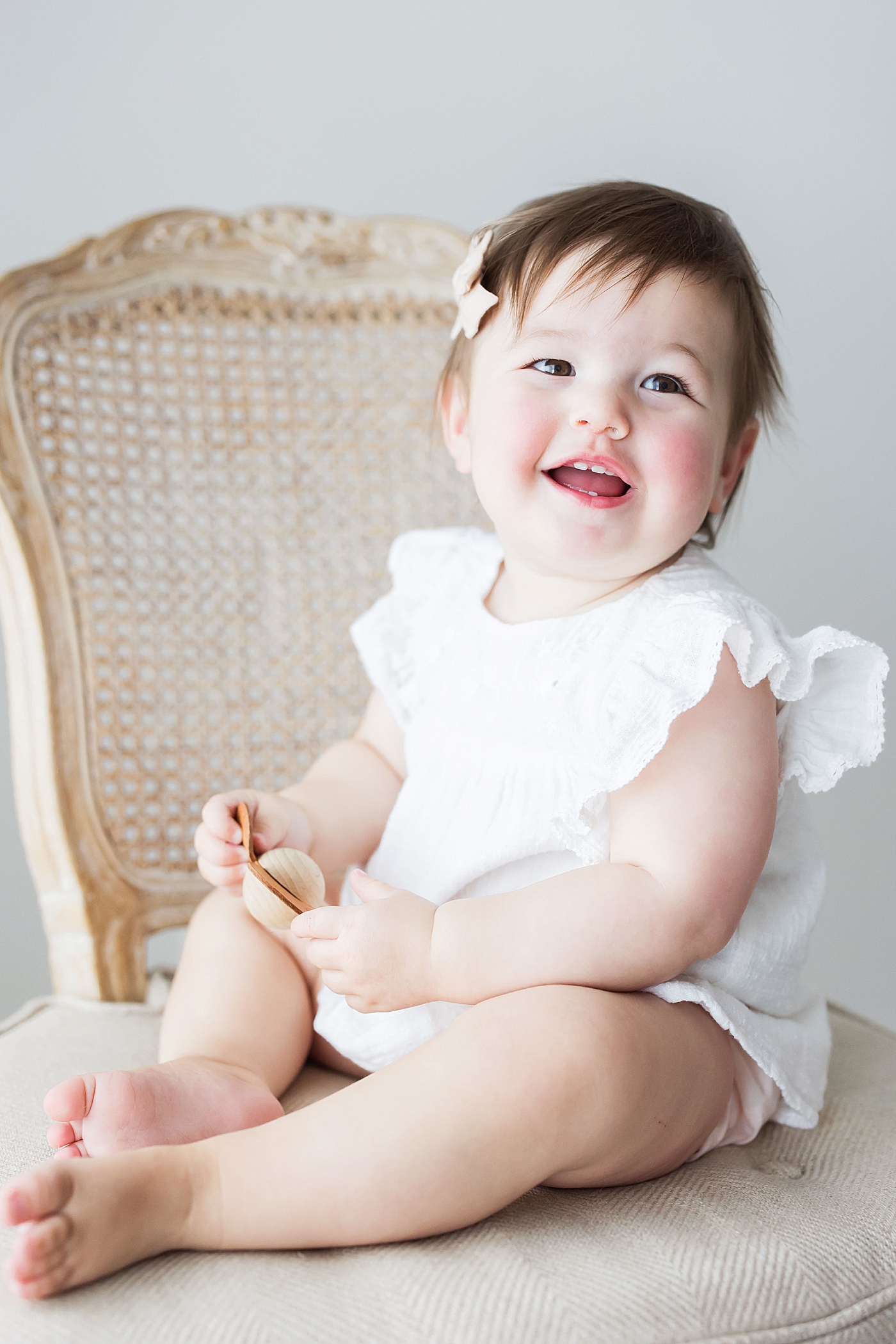 Toddler sitting in chair for portraits with Fresh Light Photography.