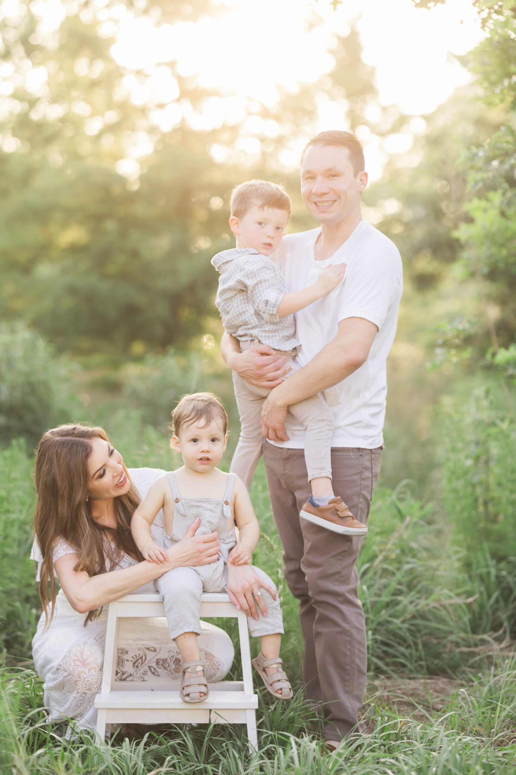 Candid moment of the family, expertly captured by Fresh Light Photography, as they share laughter and happiness amidst the stunning sunset backdrop.