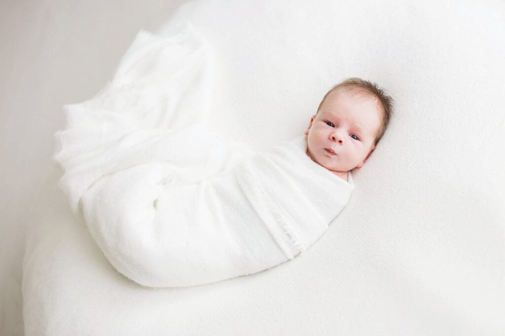 Sleeping newborn baby photographed by a professional newborn photographer in Houston, Texas