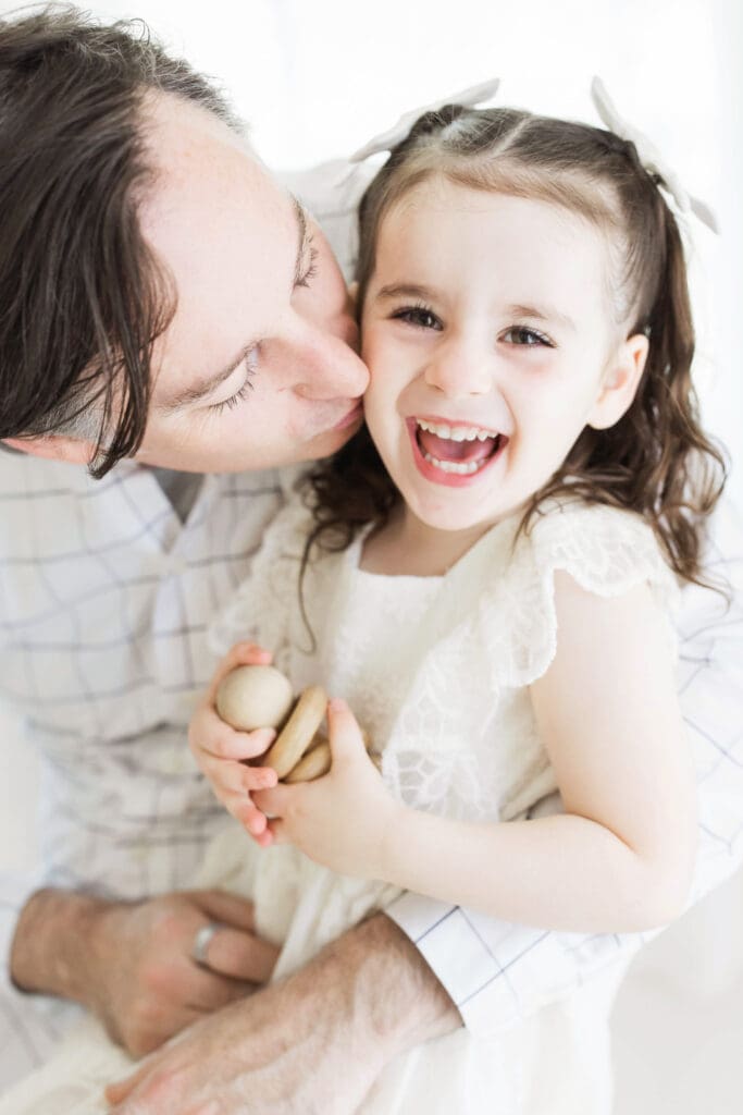 Heartwarming father and daughter portrait captured in a Houston Heights, TX photography studio