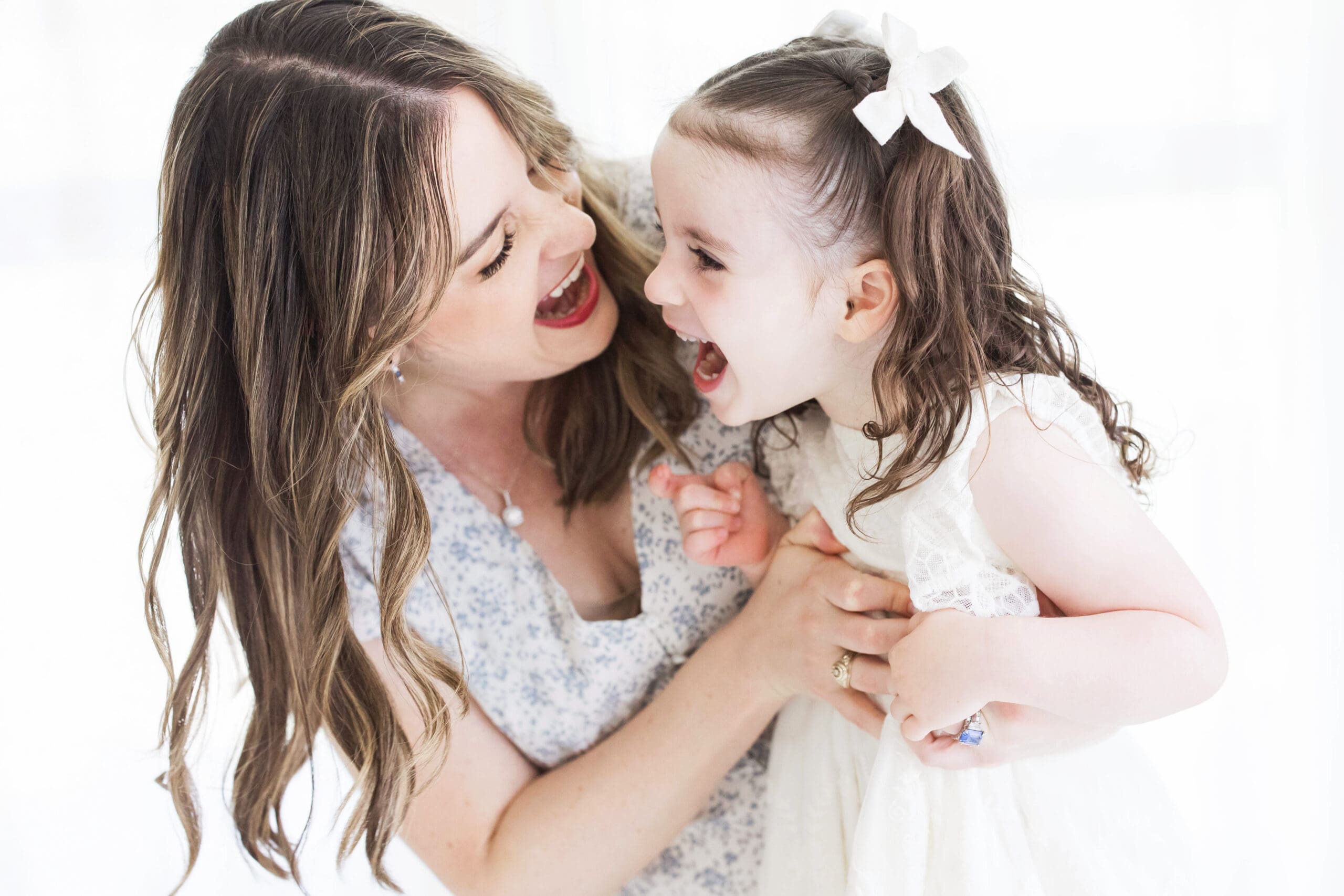 Mother and daughter posing together during a studio-based family photography session in Houston Heights, TX