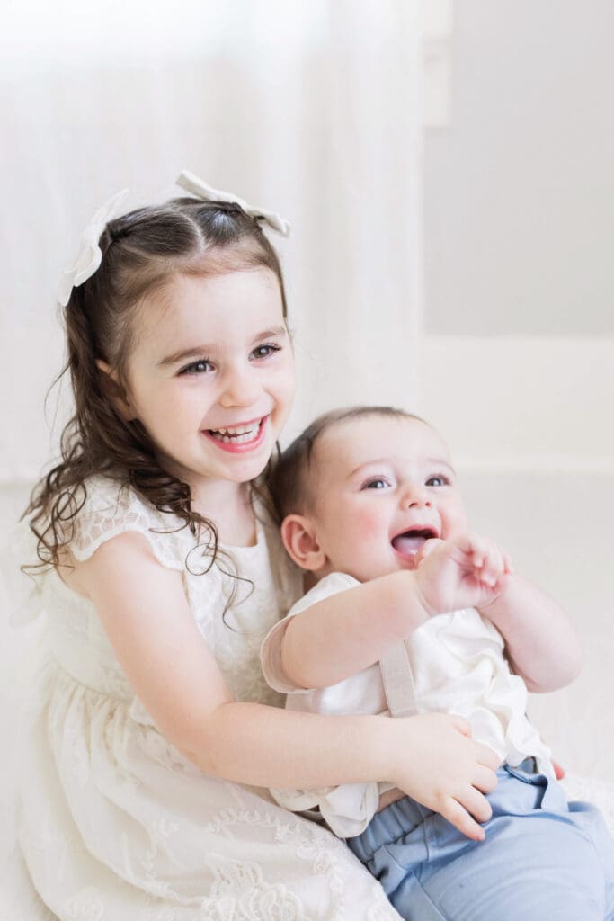 Baby with his elder sister during a studio-based family photography session in Houston Heights, TX